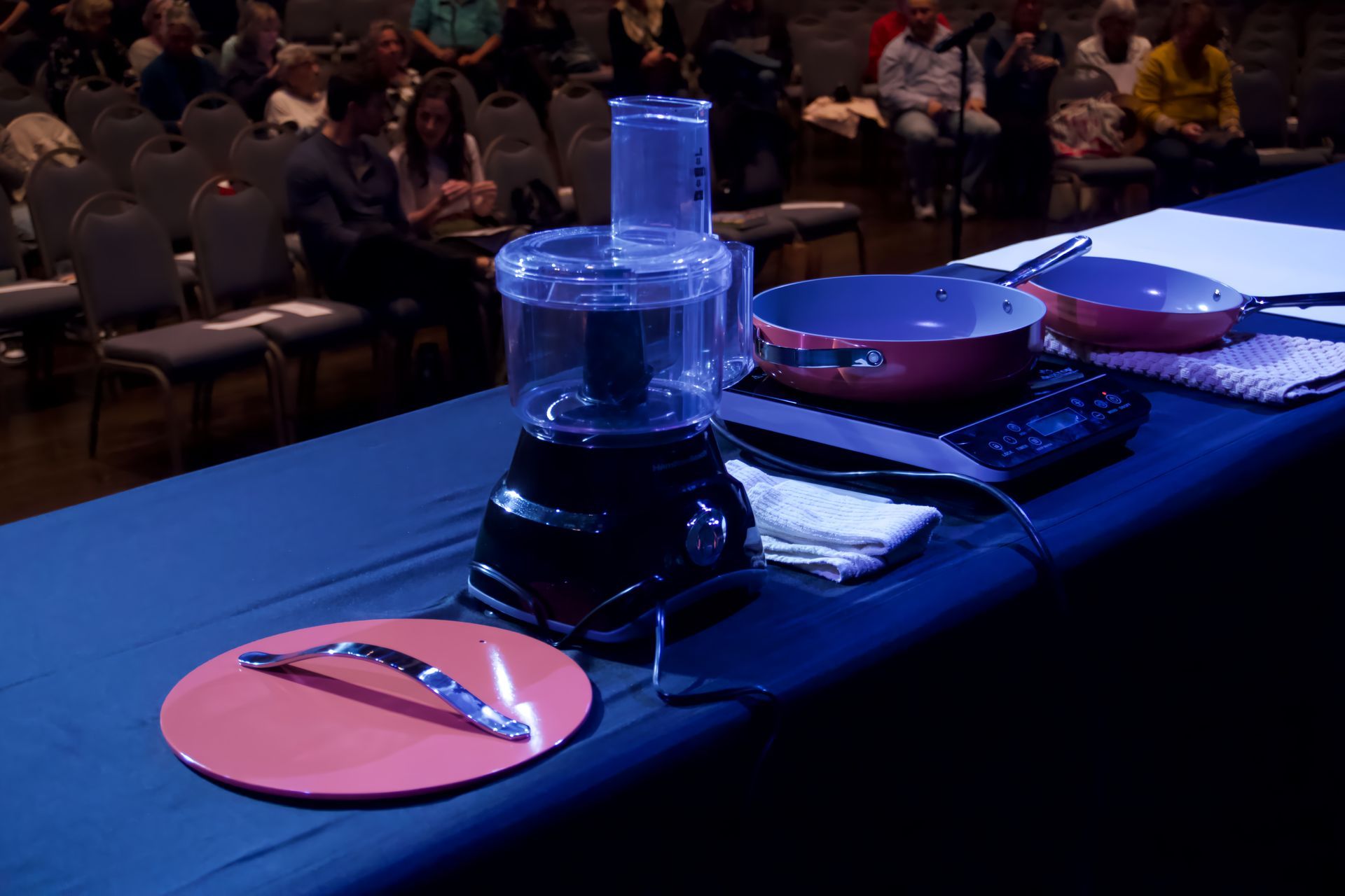 A table with a blender and pans on it