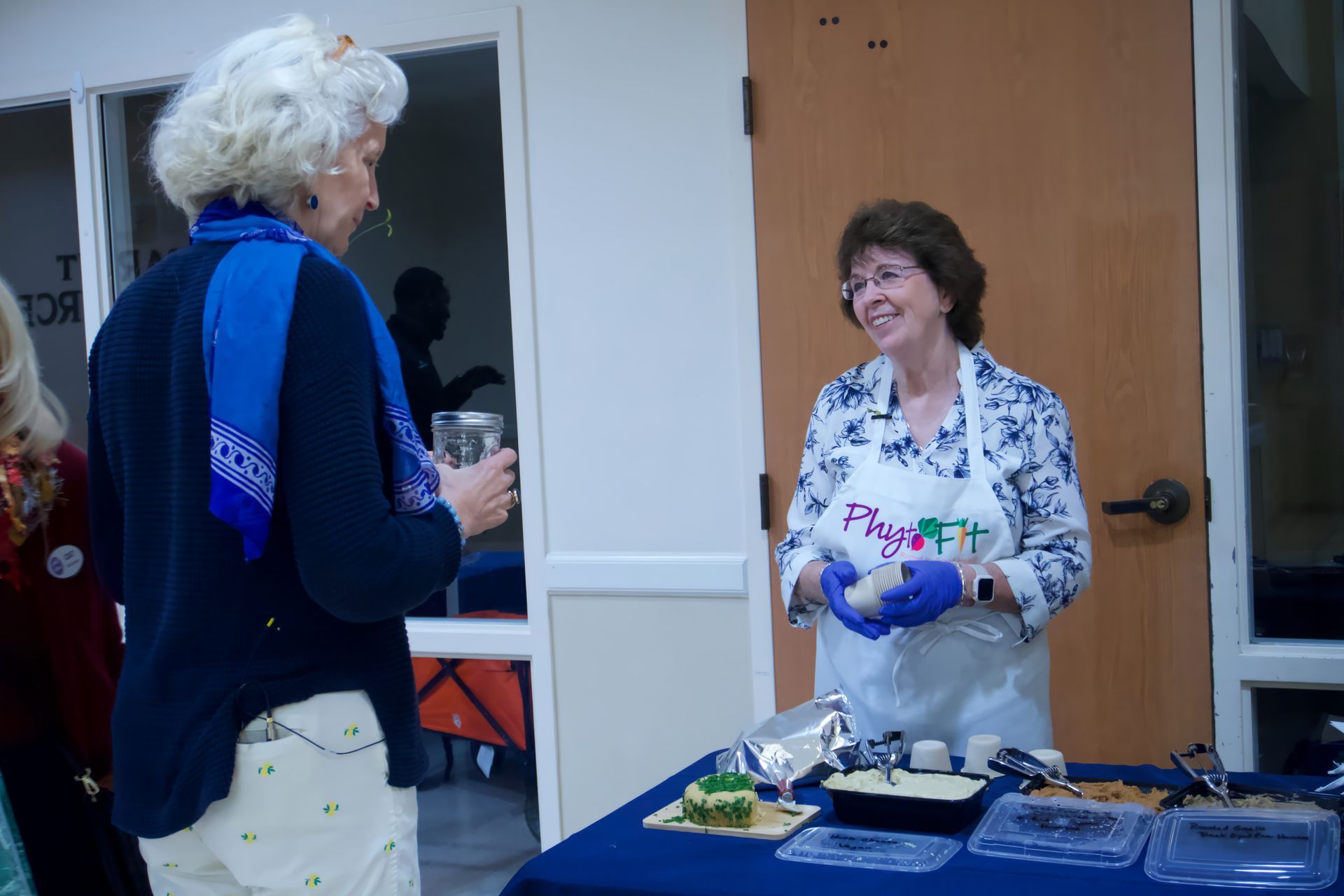 A woman wearing an apron with the word project on it