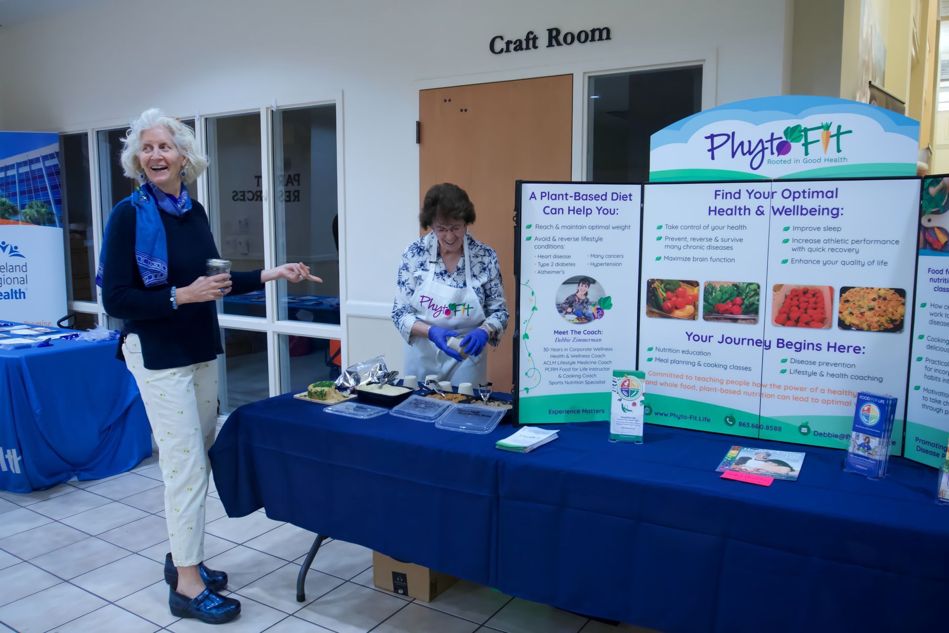 A woman is standing in front of a table with a sign that says flight fit on it.