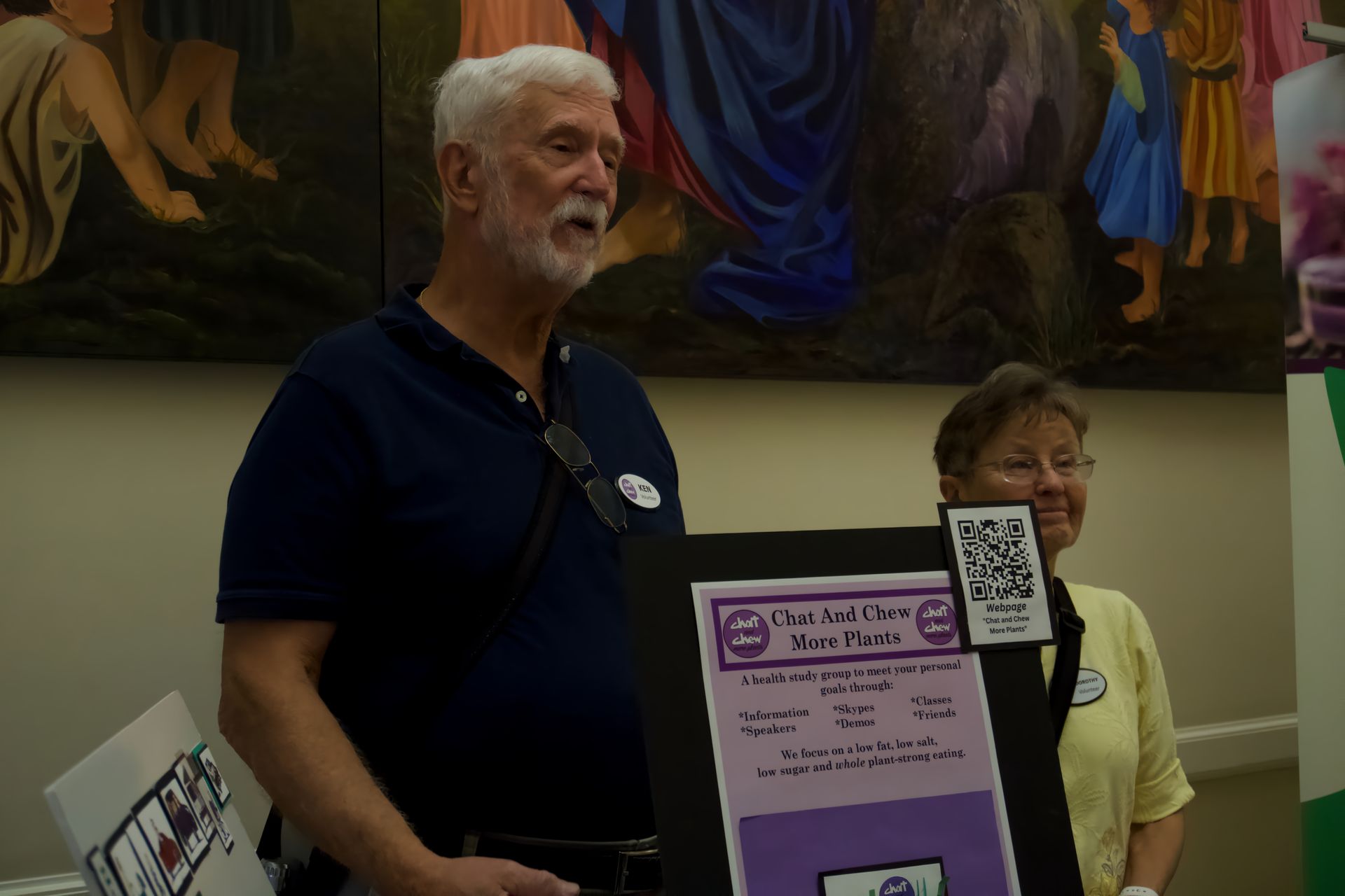 A man and a woman standing next to each other holding a sign that says ' city craft fair ' on it