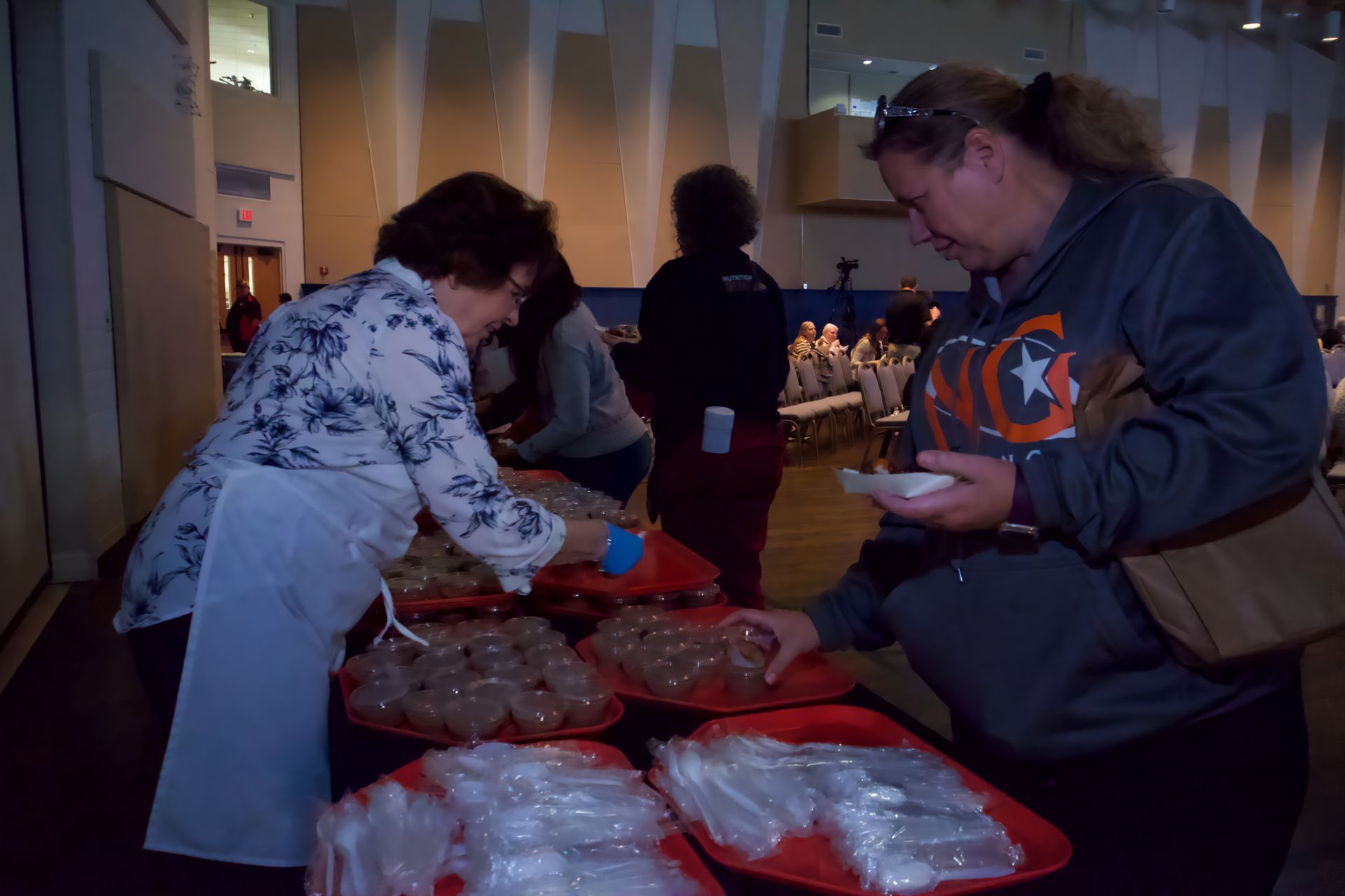 A woman wearing a sweatshirt with the letter g on it