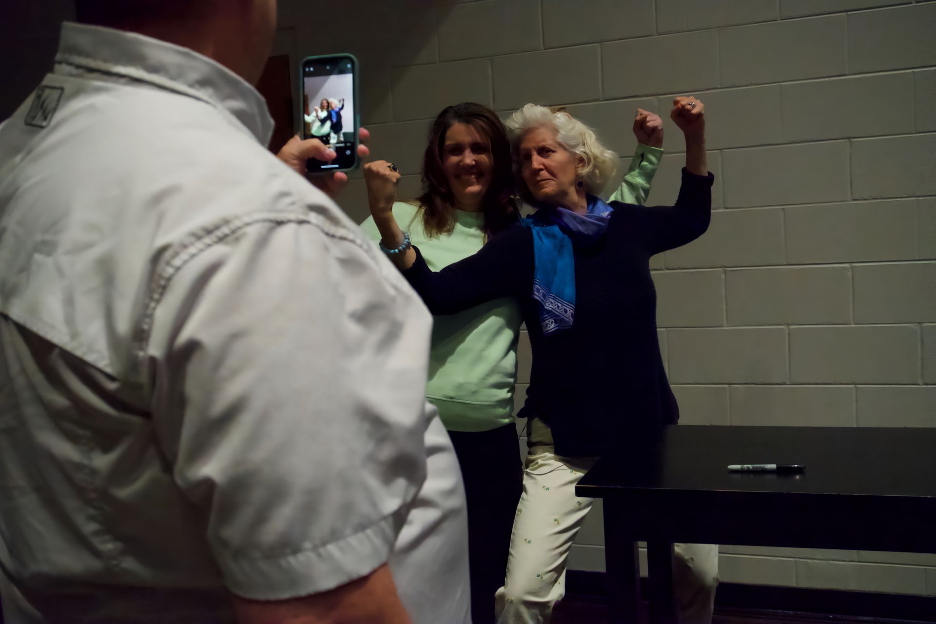 A man is taking a picture of two women