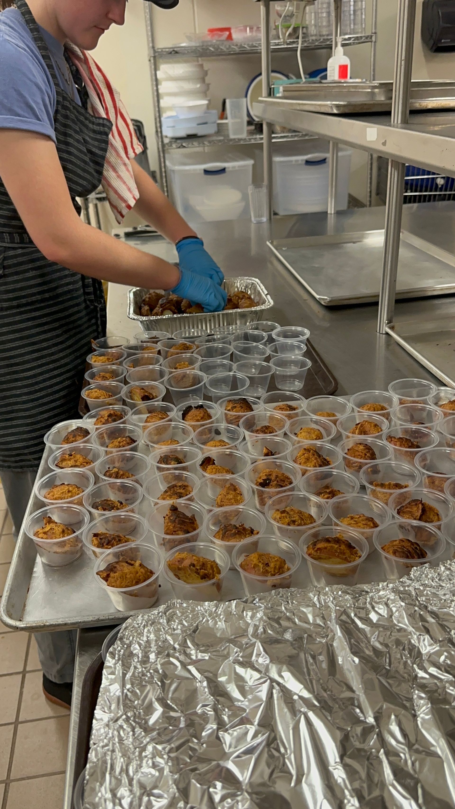 A woman is preparing food in a kitchen.