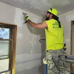 Family gathered at a dining table in a kitchen. They are eating and talking together.