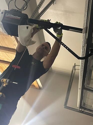 Man using a remote controller to open the garage door.