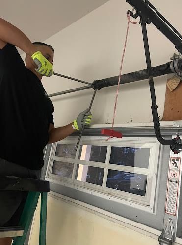 Man using a remote controller to open the garage door.