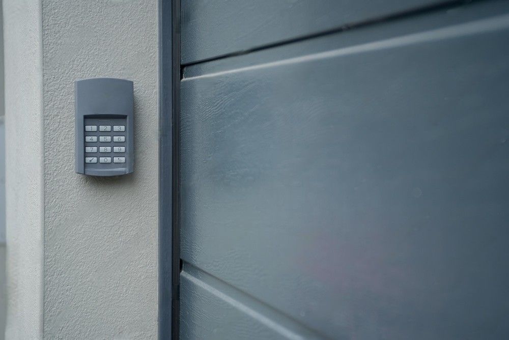 Man using a remote controller to open the garage door.