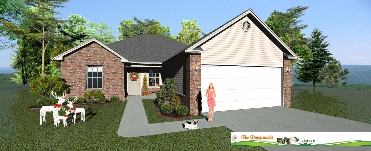 House with brick facade, trees, and a woman standing in front of a garage. Christmas deer are in the yard.