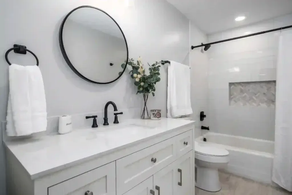 Modern white bathroom with a sink, mirror, and bathtub.