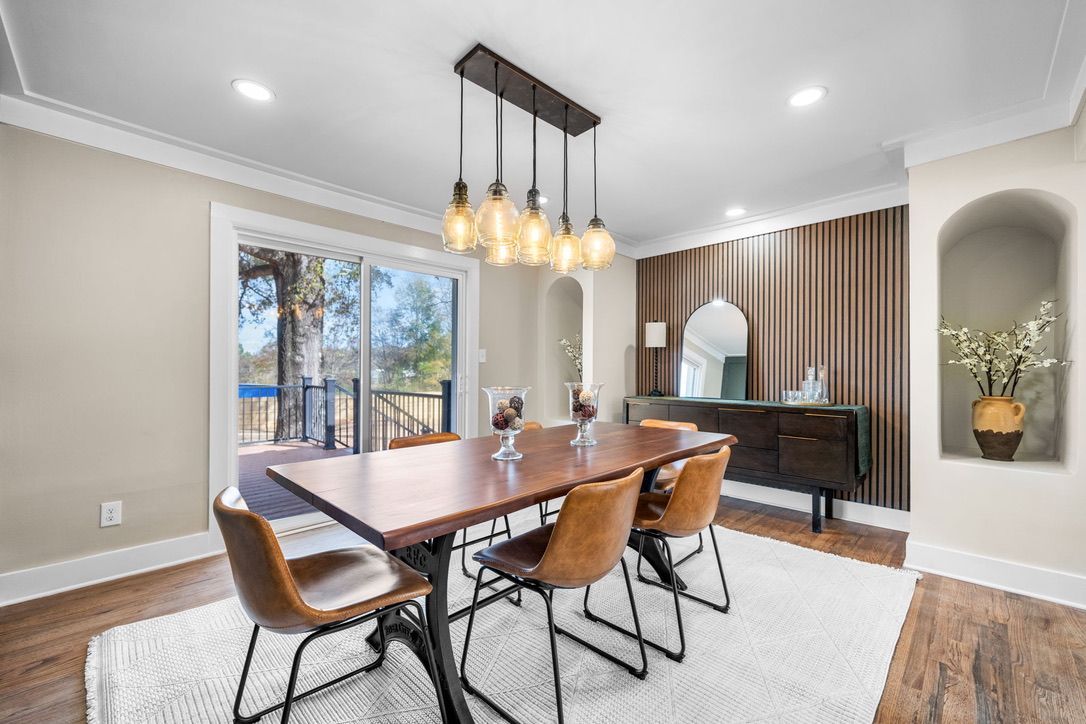 Man installing wood-look flooring. Indoors, construction in progress. Floor and wall protection visible.