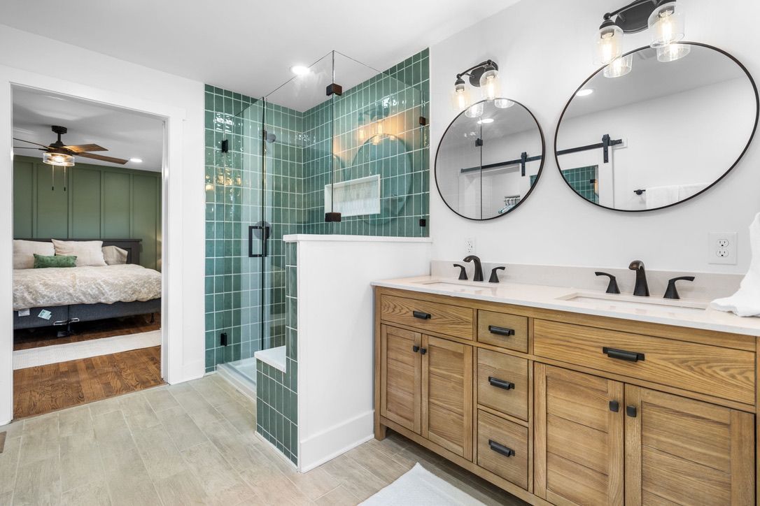 Double wooden front doors with wreath and doormat.