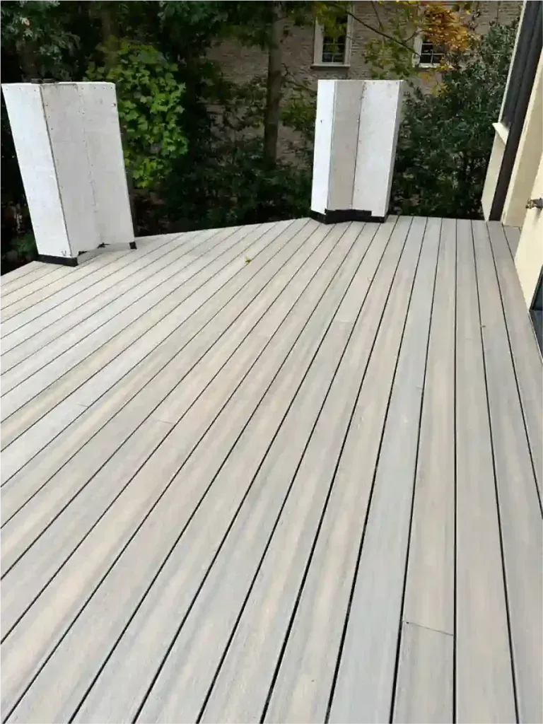 Gray composite deck with three white structural supports; exterior setting.
