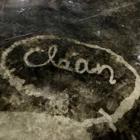 a silhouette of the word clean on the floor