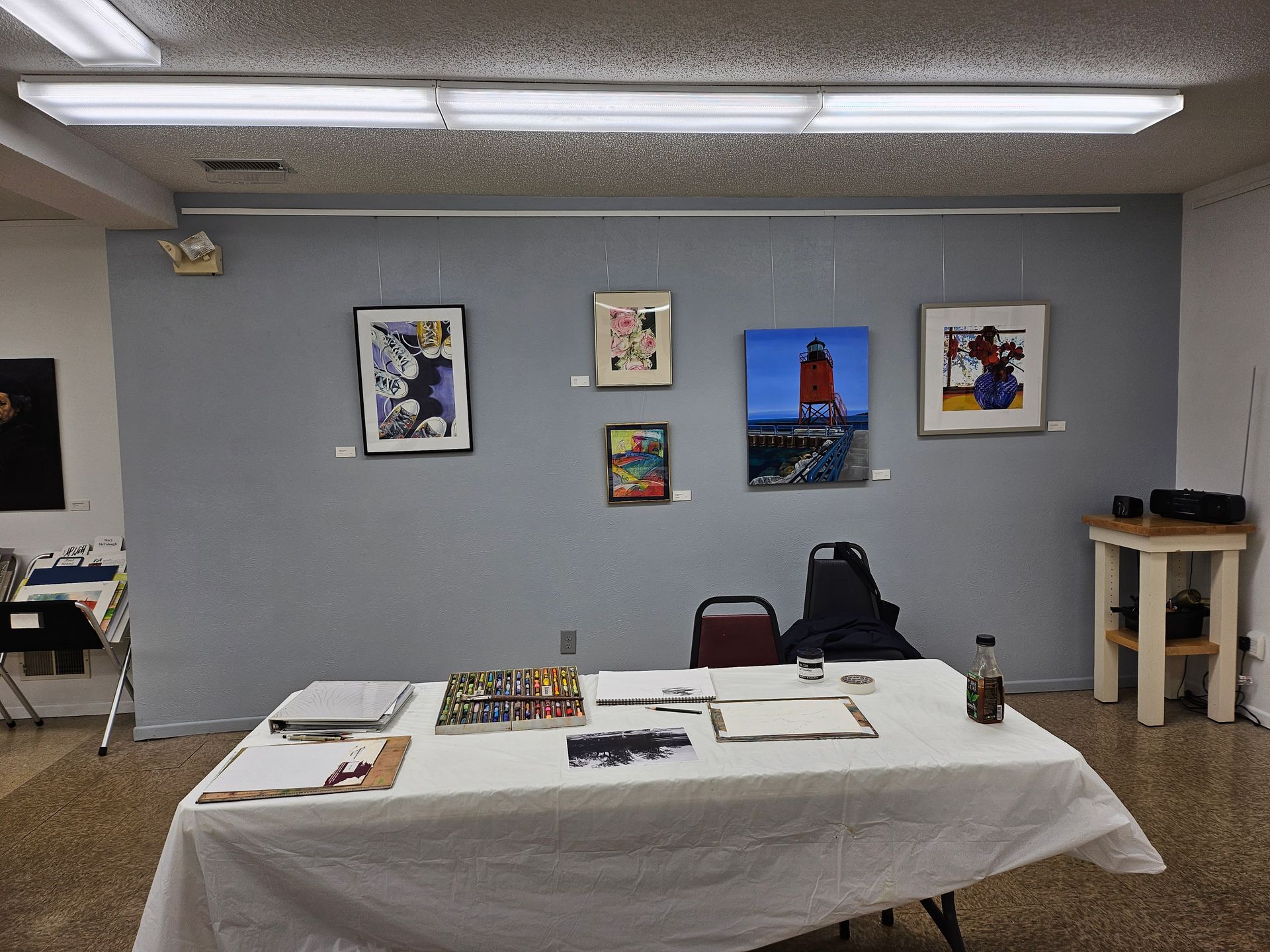 A room with a table and paintings on the wall
