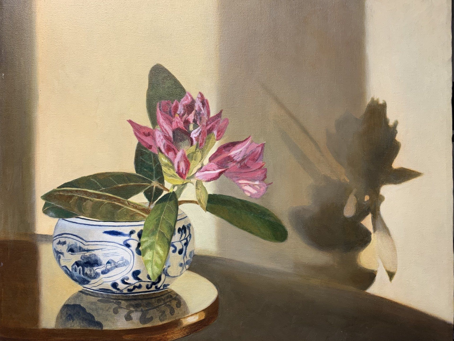 A painting of a flower in a blue and white vase on a table.