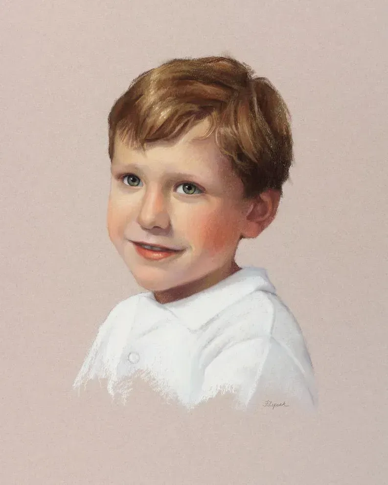 A portrait of a young boy in a white shirt on a pink background.
