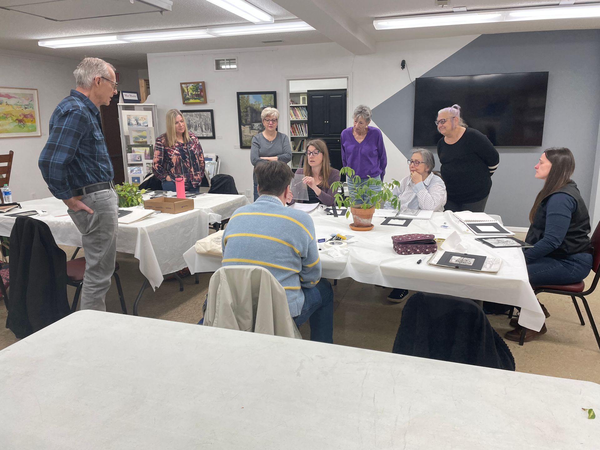 A group of people are sitting at tables in a room.