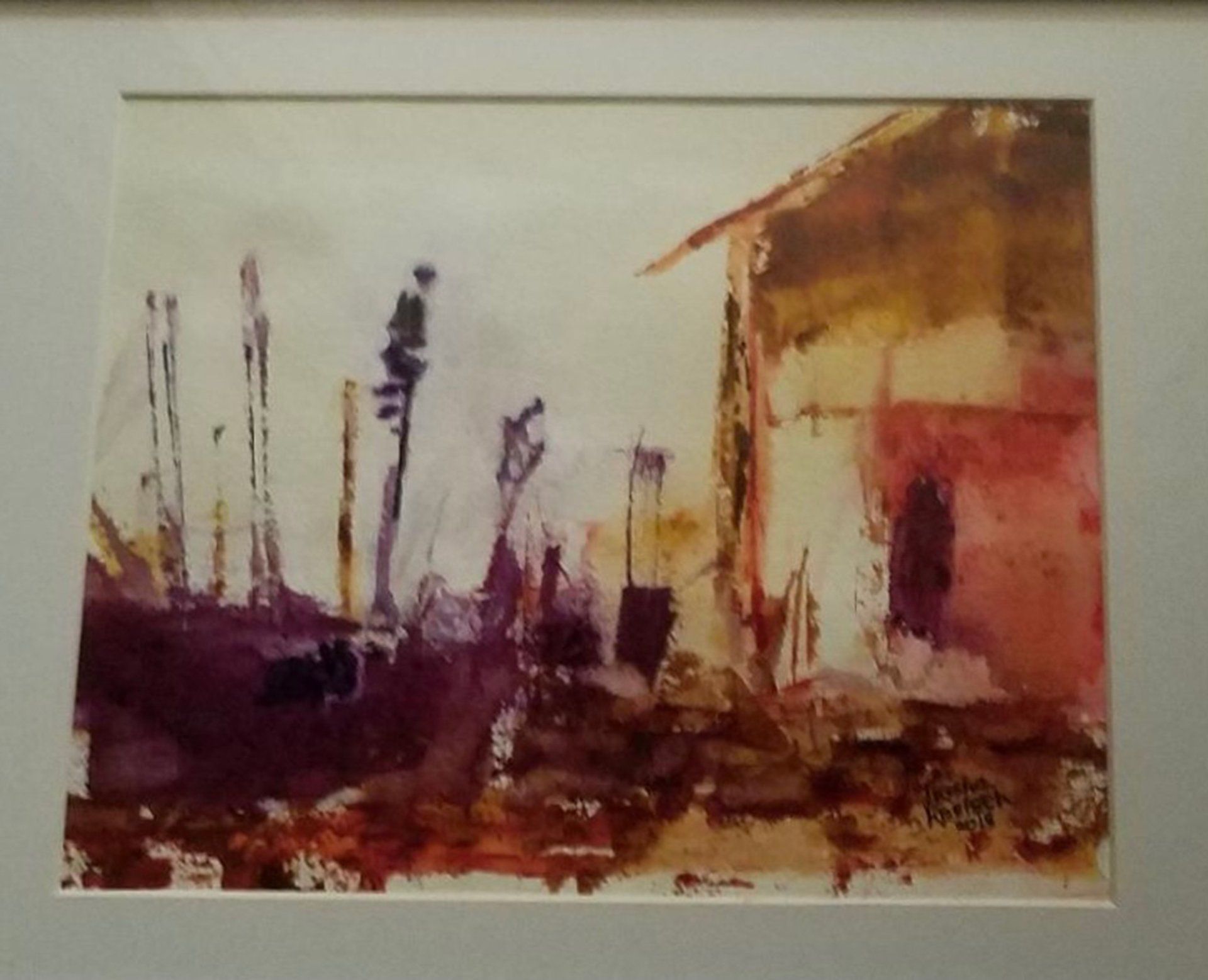 A framed painting of a house with trees in the background