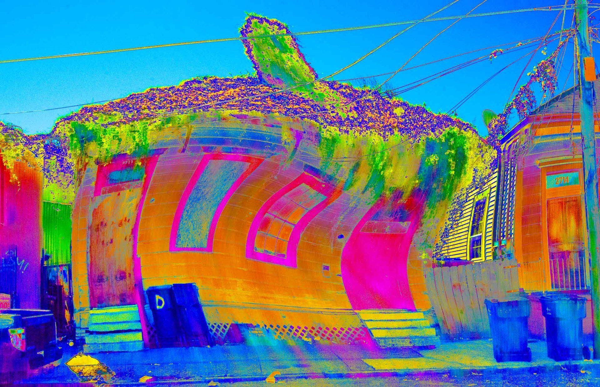 A colorful painting of a house with a turtle on the roof.