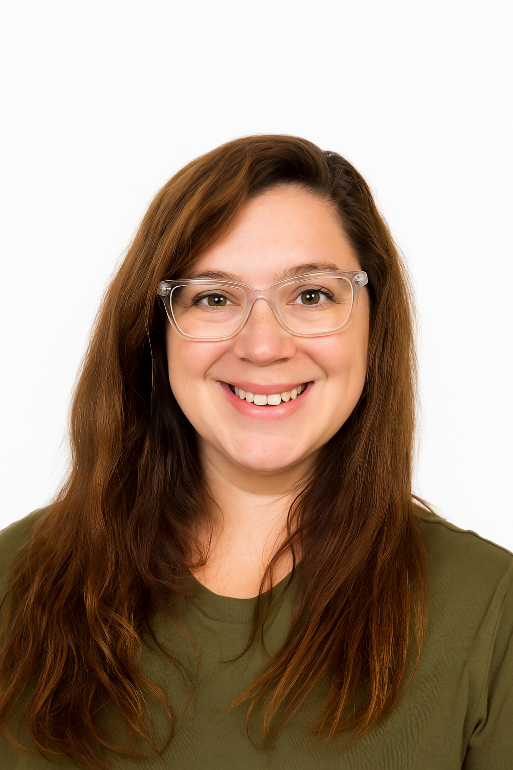 A woman wearing glasses and a blue shirt is standing with her arms crossed.