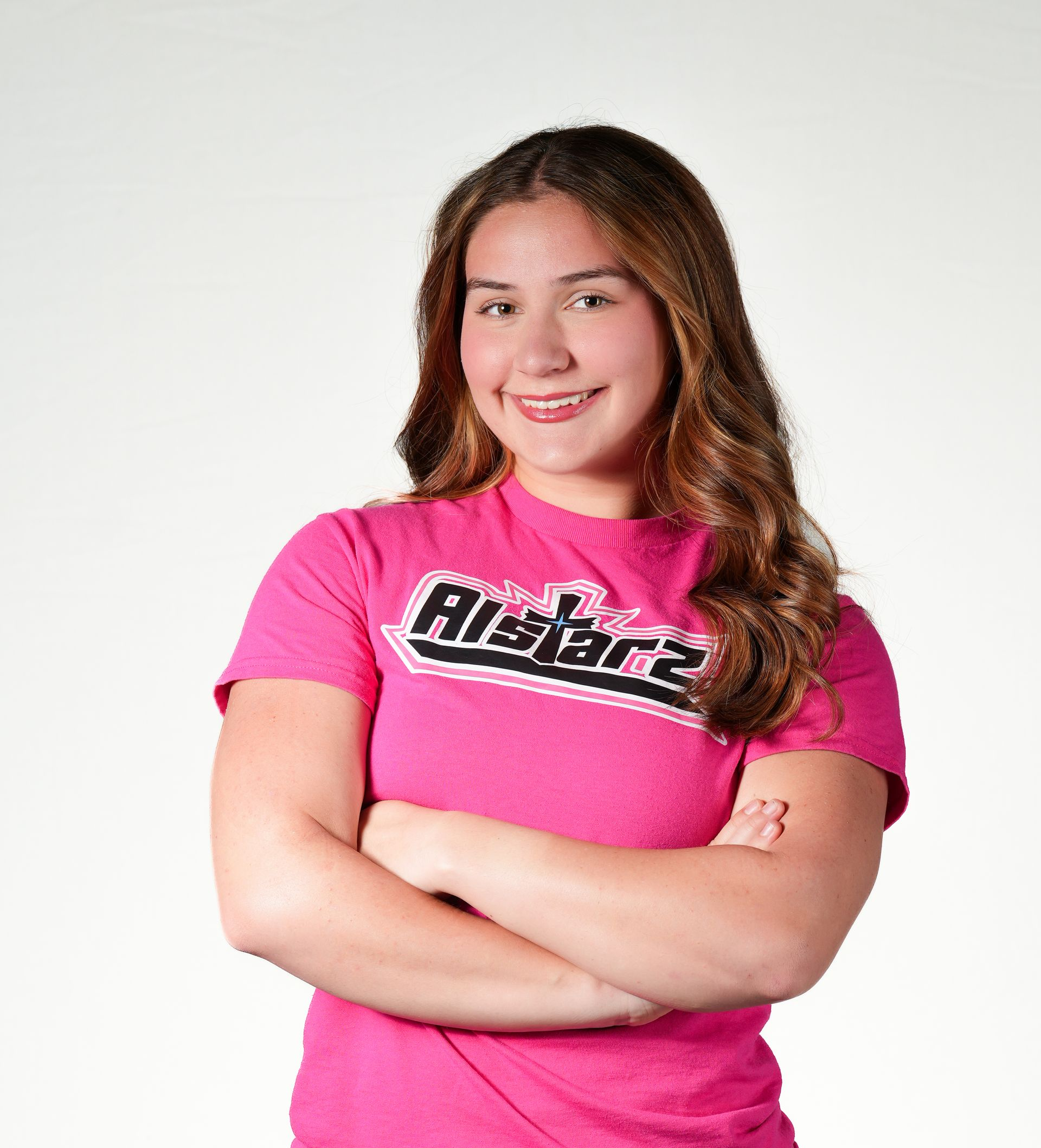 A cheerleader is wearing a red top and a red skirt.