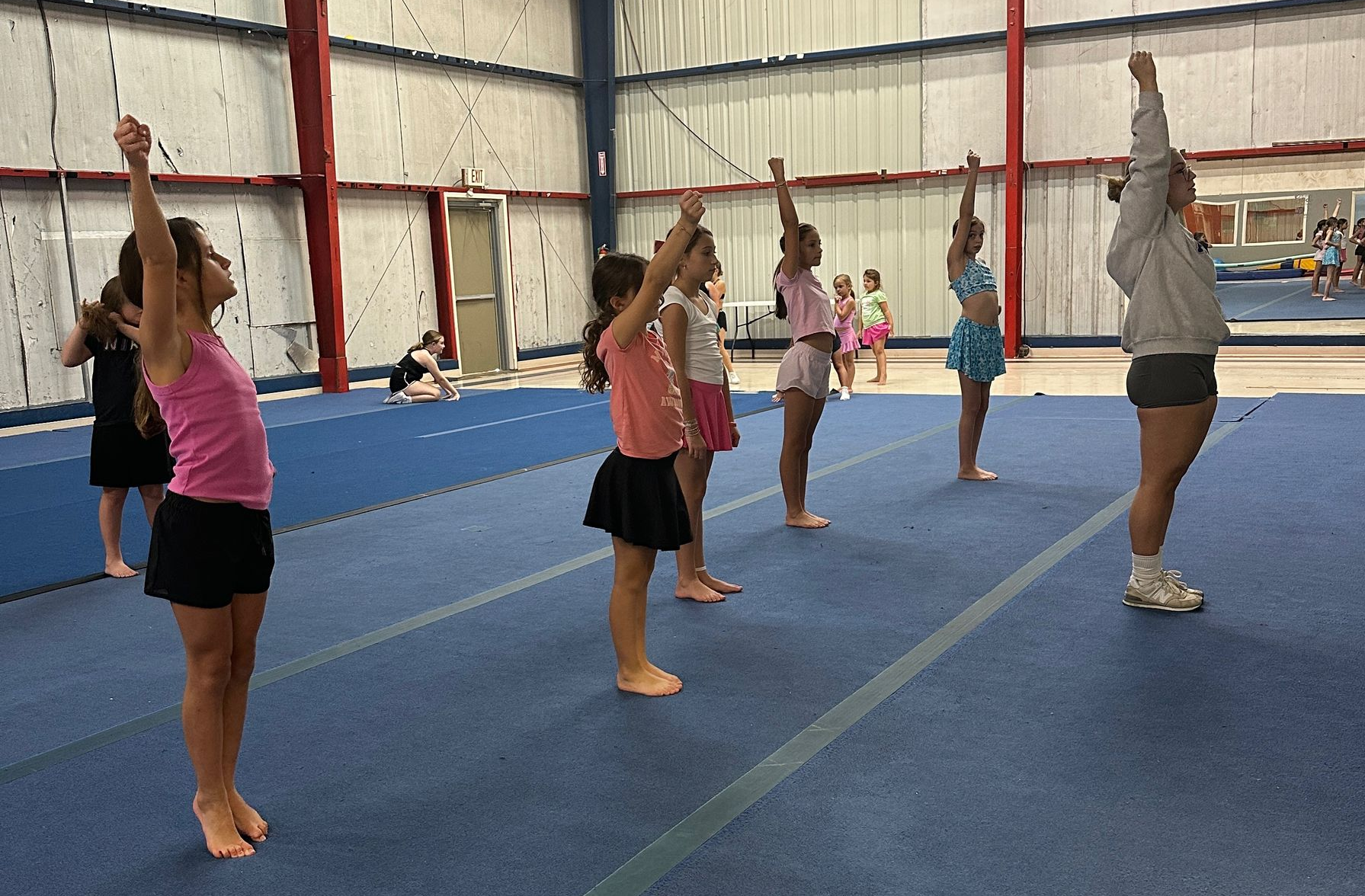 A group of children are standing next to each other and smiling.