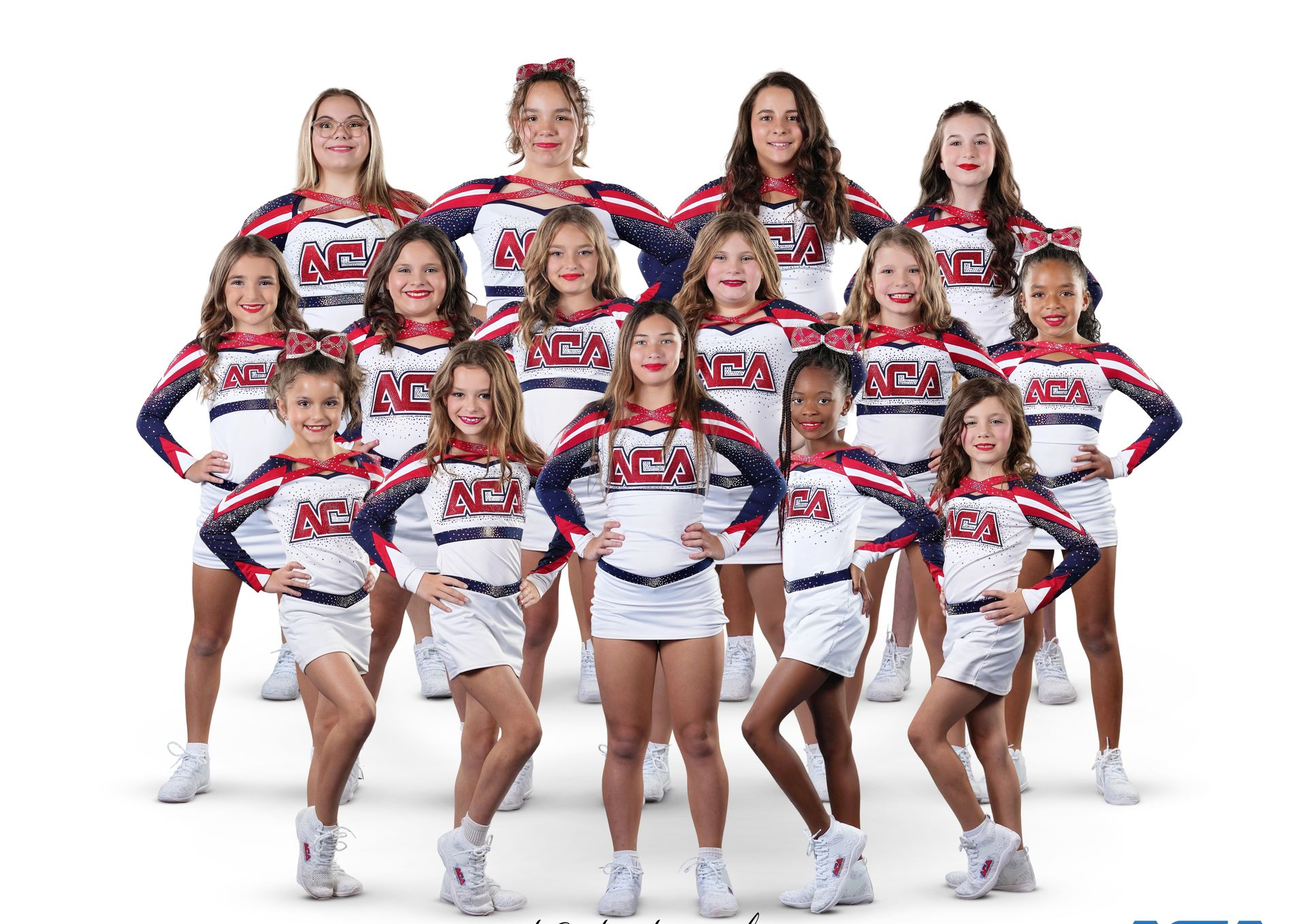 A group of cheerleaders are posing for a picture.