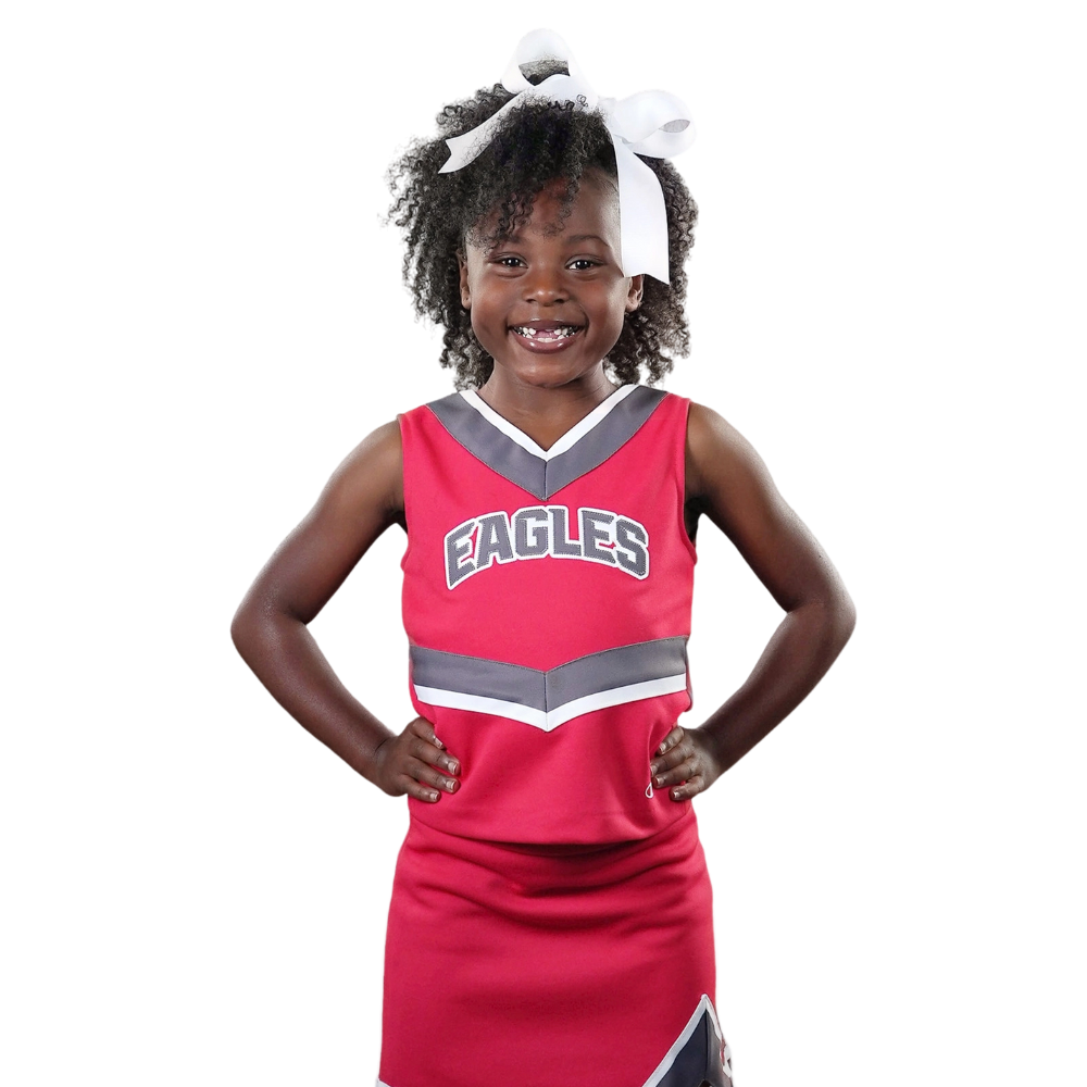 A little girl is wearing an eagles cheer uniform