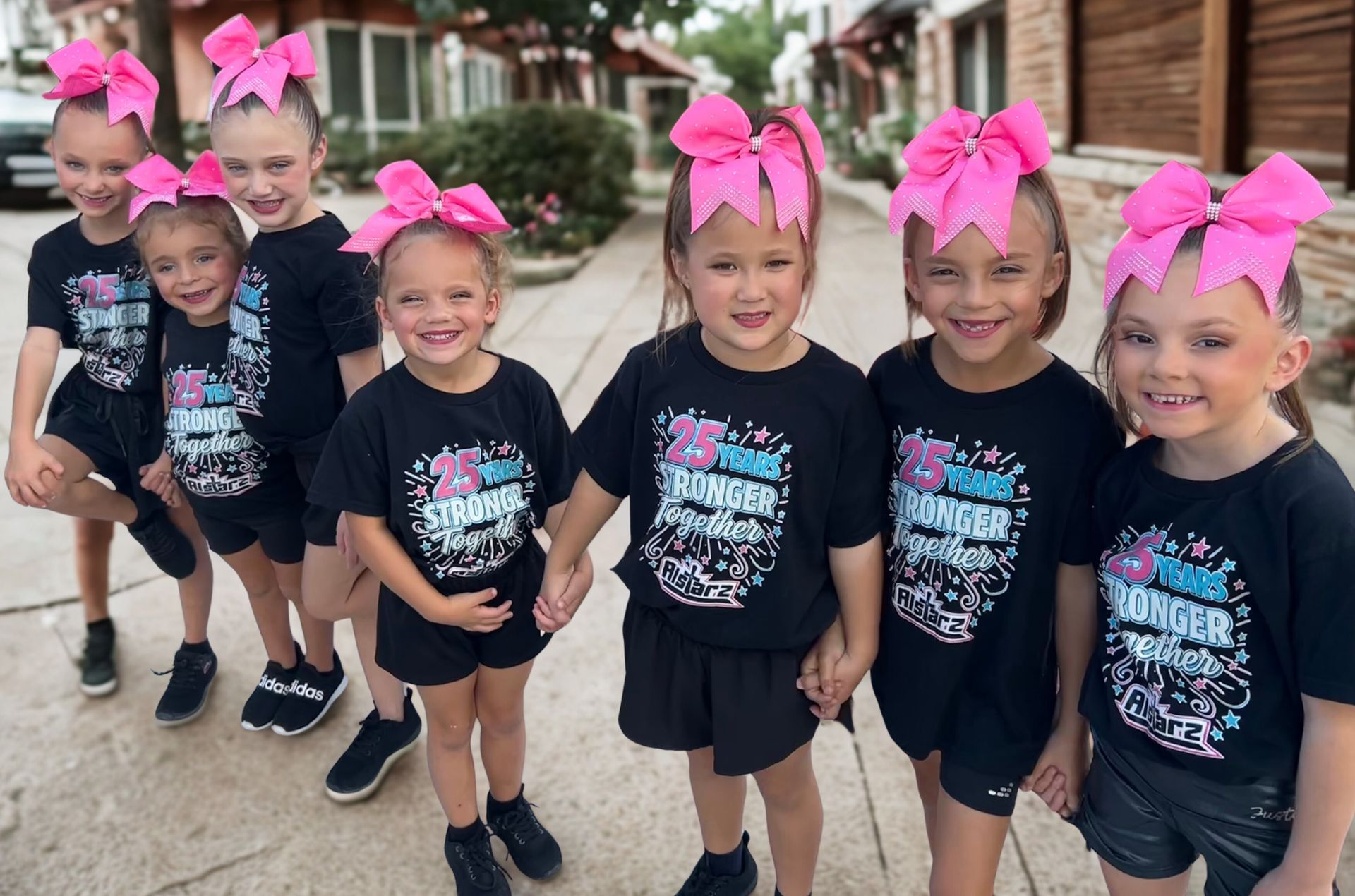 A group of young girls are posing for a picture in a gym.