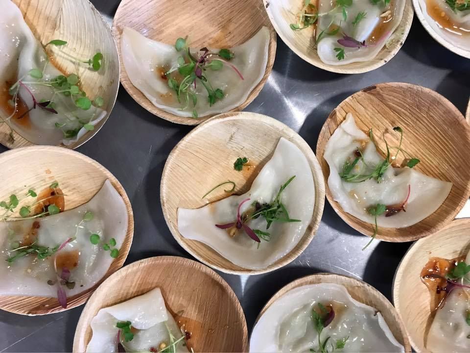 A bunch of small bowls filled with food on a table.