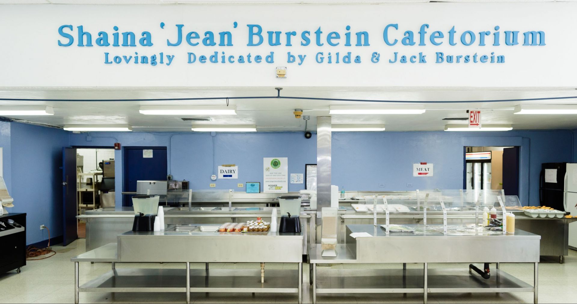 A kitchen with a sign that says shaina jean burstein cafetorium