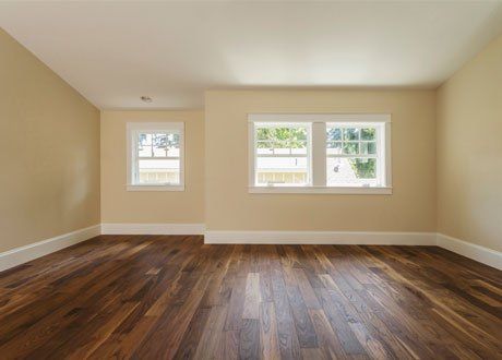 newly installed hardwood flooring for a house painted with yellow colour on walls