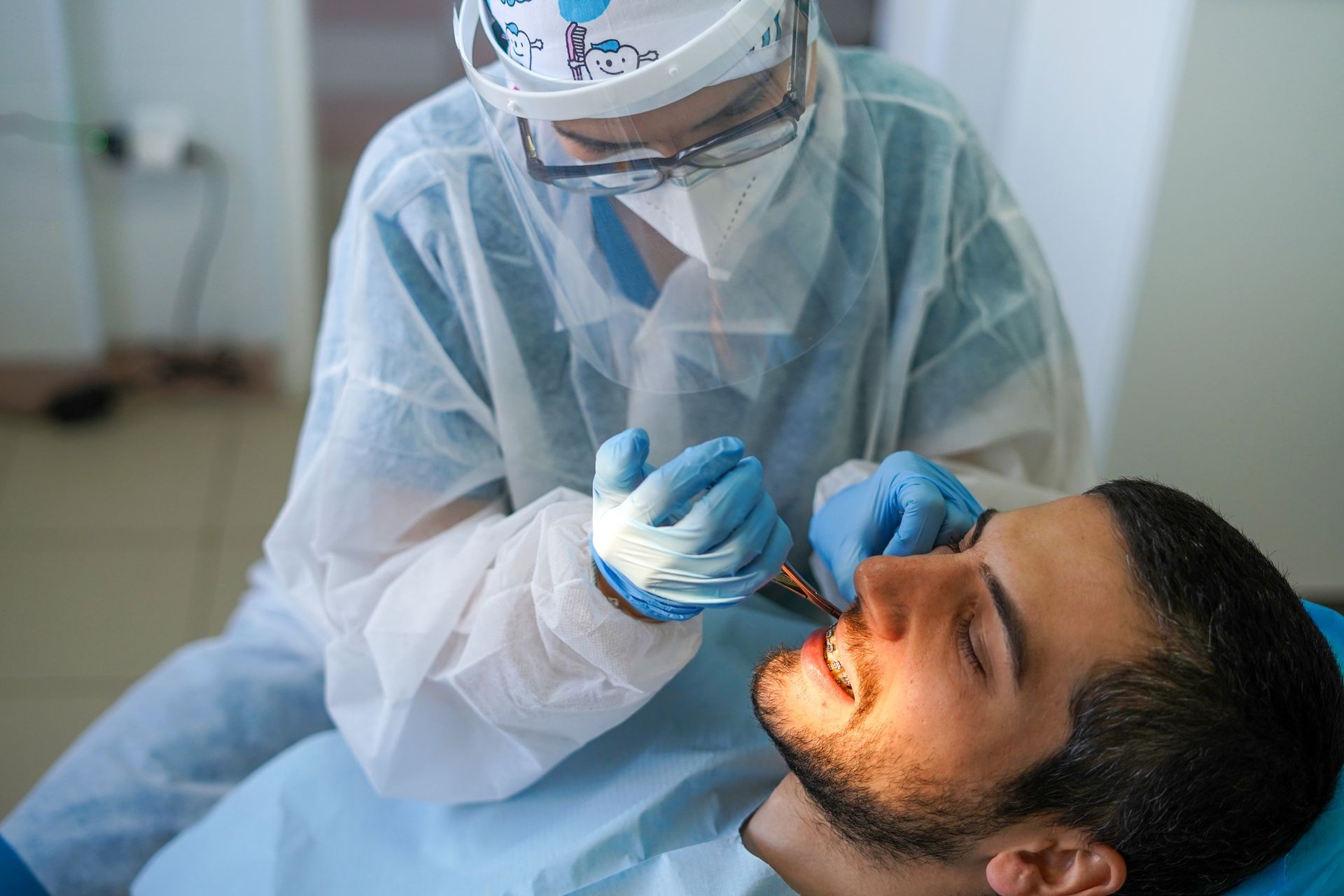 Orthodontist examining patients teeth in dentist's office. Orthodontist examining patients teeth in dentist's office.