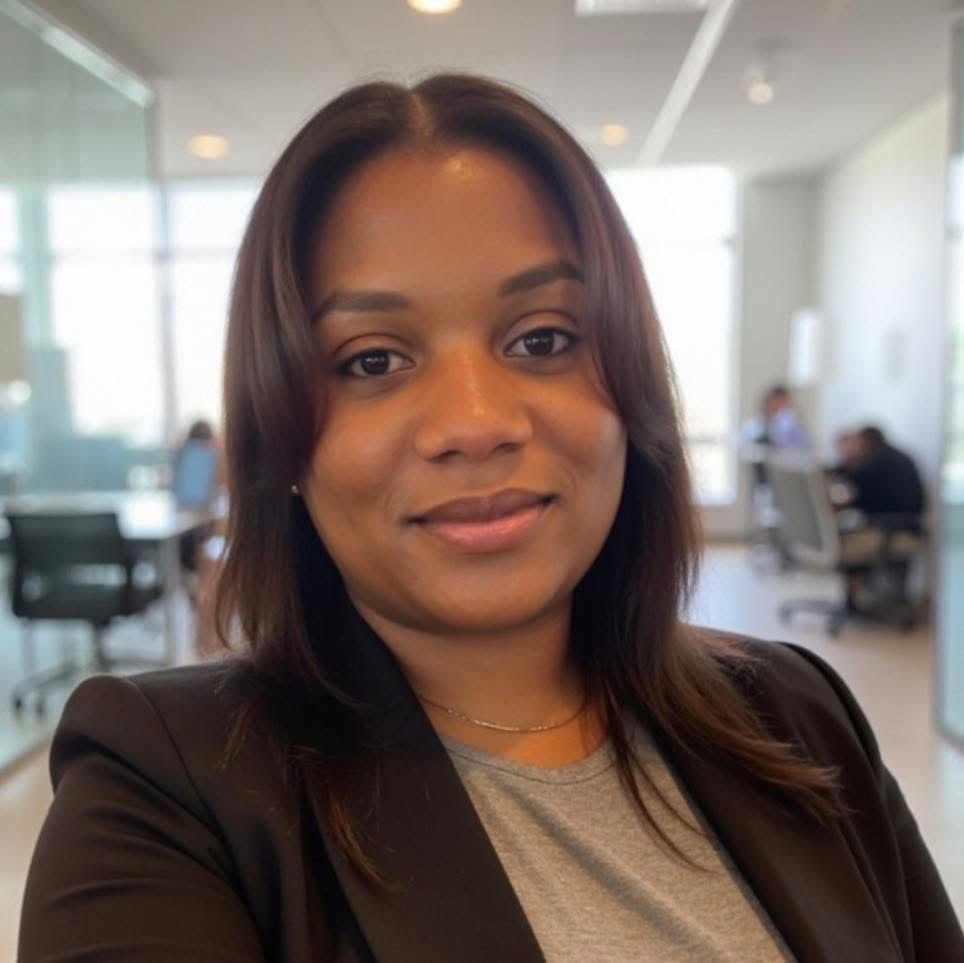A man and a woman are sitting on a dock overlooking a lake.