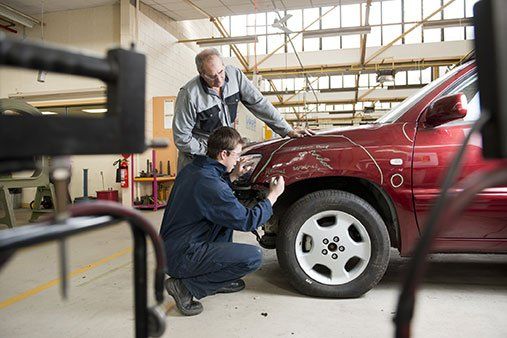 Mechanics checking damaged  - Auto Shop in Camarillo, CA