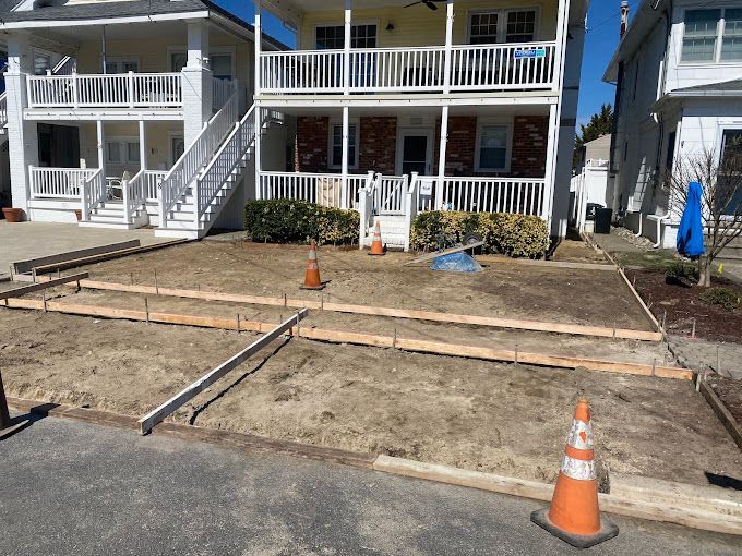 A driveway is being built by stone works masonry inc. in front of a house