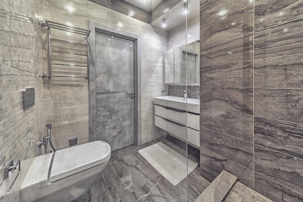 Modern Bathroom With Gray Tile Walls and Floor, Toilet, Sink, and Shower — ABV Plumbing In The entrance, NSW