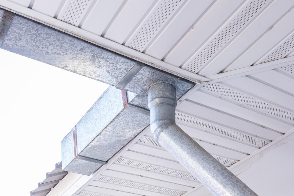 Gutter System on a White Building With a Metal Downspout — ABV Plumbing In Avoca Beach, NSW