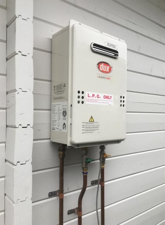 A White Dux Instantaneous Hot Water Heater — ABV Plumbing In Woy Woy, NSW