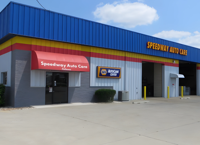 Speedway Auto Care storefront with blue roof, red awnings, and open service bays | Speedway Auto Care