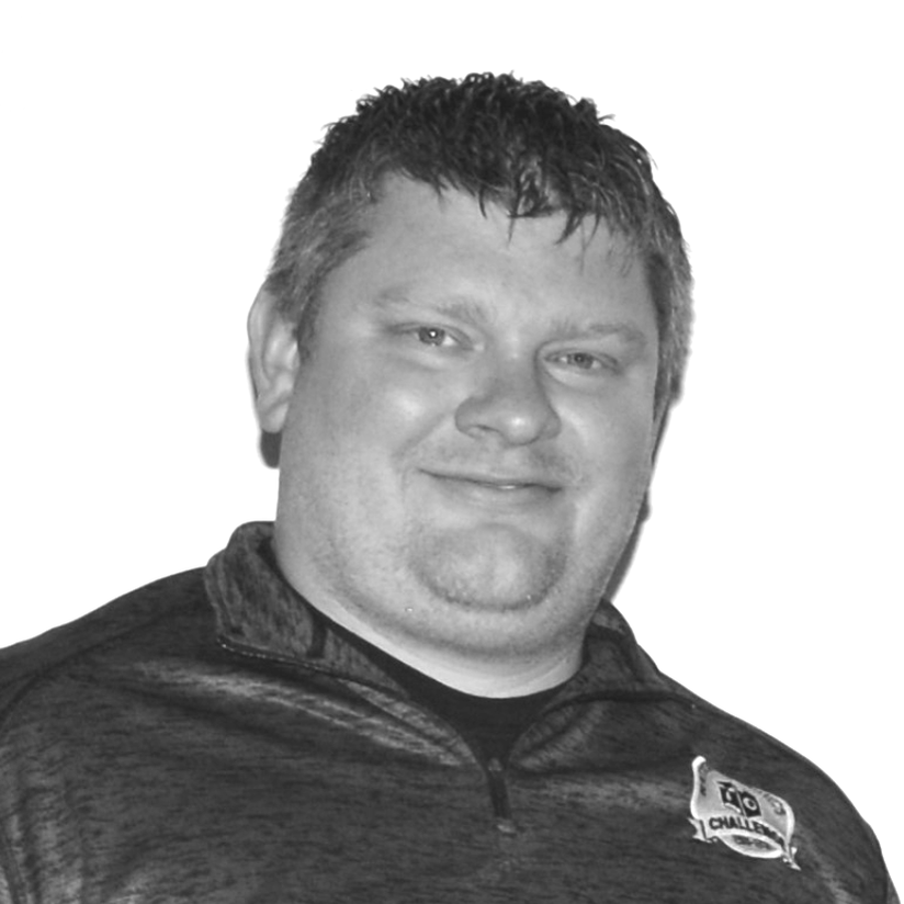 A black and white photo of a man wearing a shirt that says taco challenge