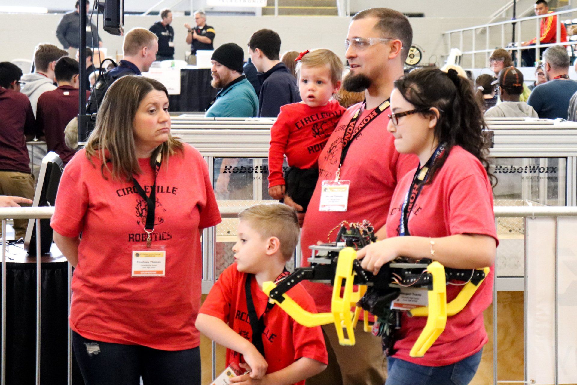 A group of people wearing red shirts are standing next to each other.