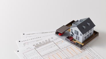 Model house on top of blueprints.