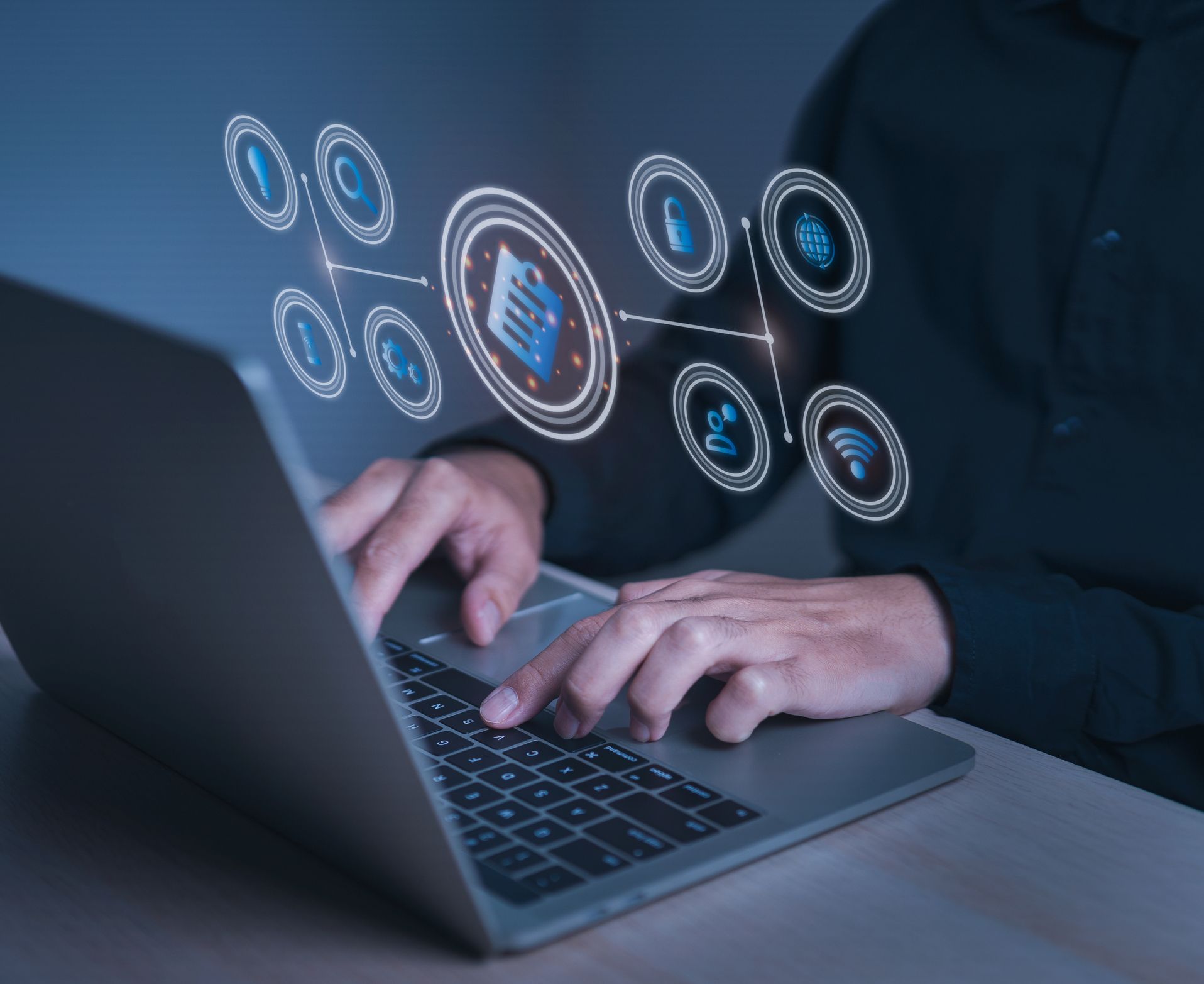 Person using laptop, surrounded by glowing digital icons representing data and connectivity.