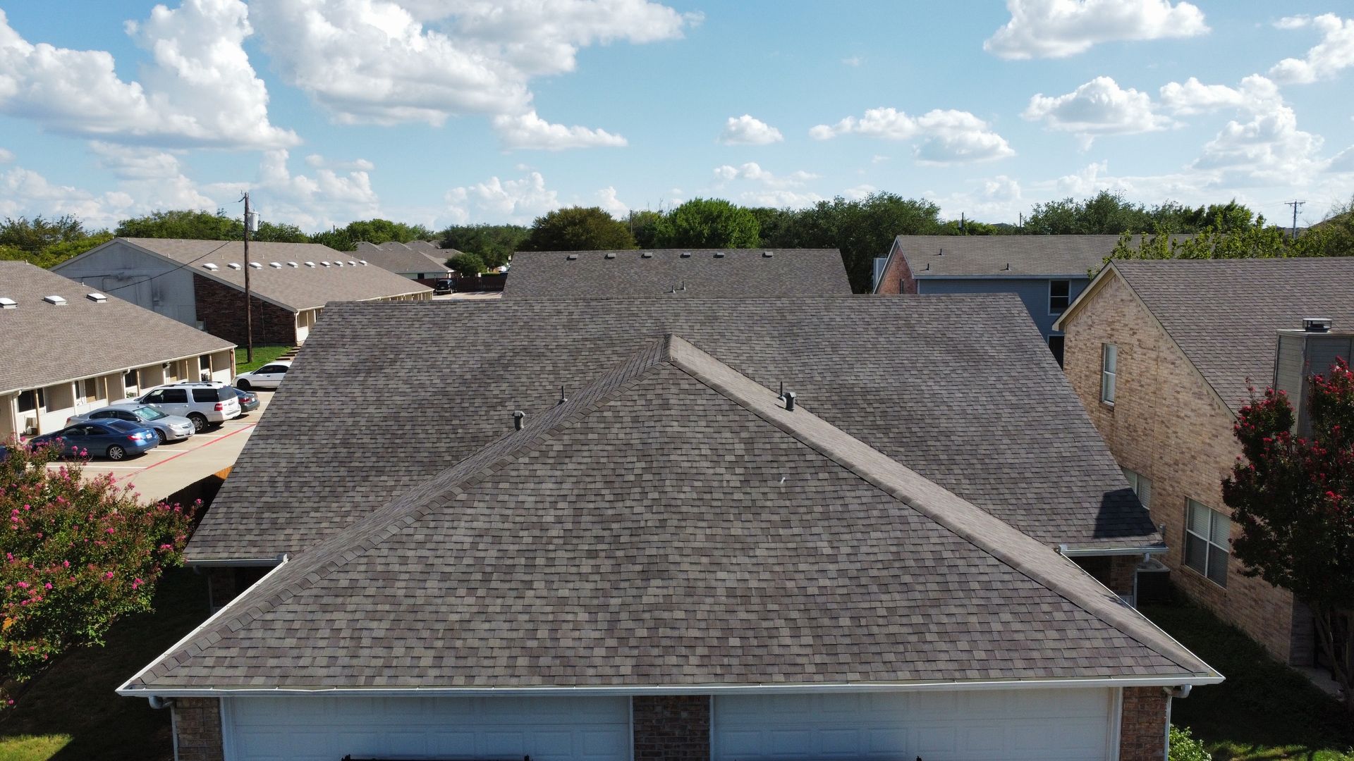 An aerial view of a roof of a house in a residential area.
