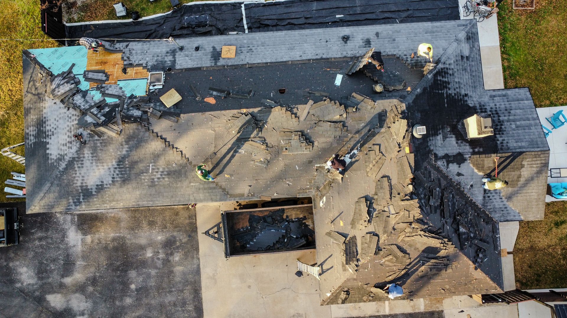 An aerial view of a brick apartment building with a car parked in front of it.