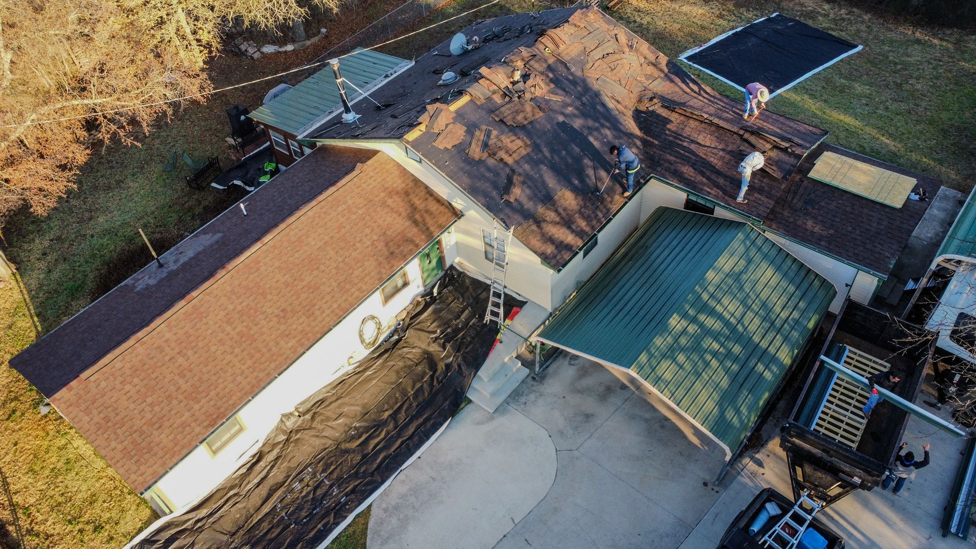 A group of people are working on the roof of a building.