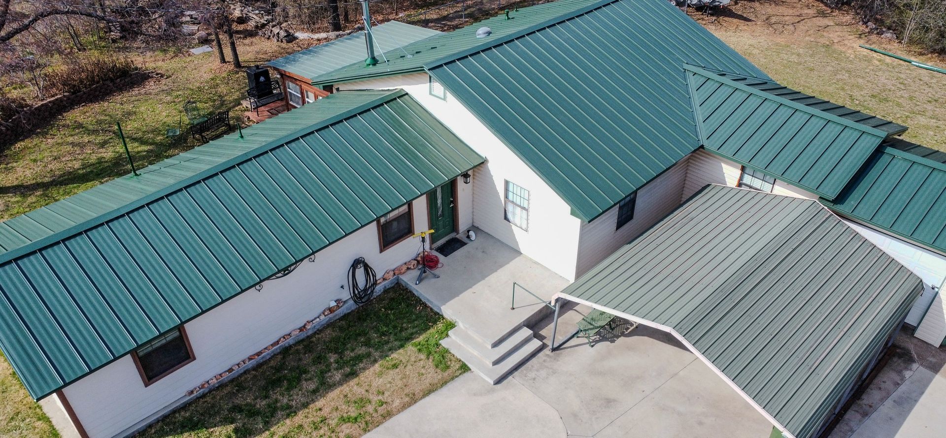 An aerial view of a brick apartment building in a residential area
