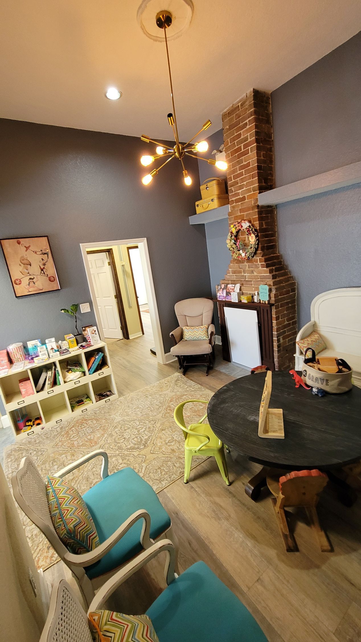 A living room with a table and chairs and a fireplace.