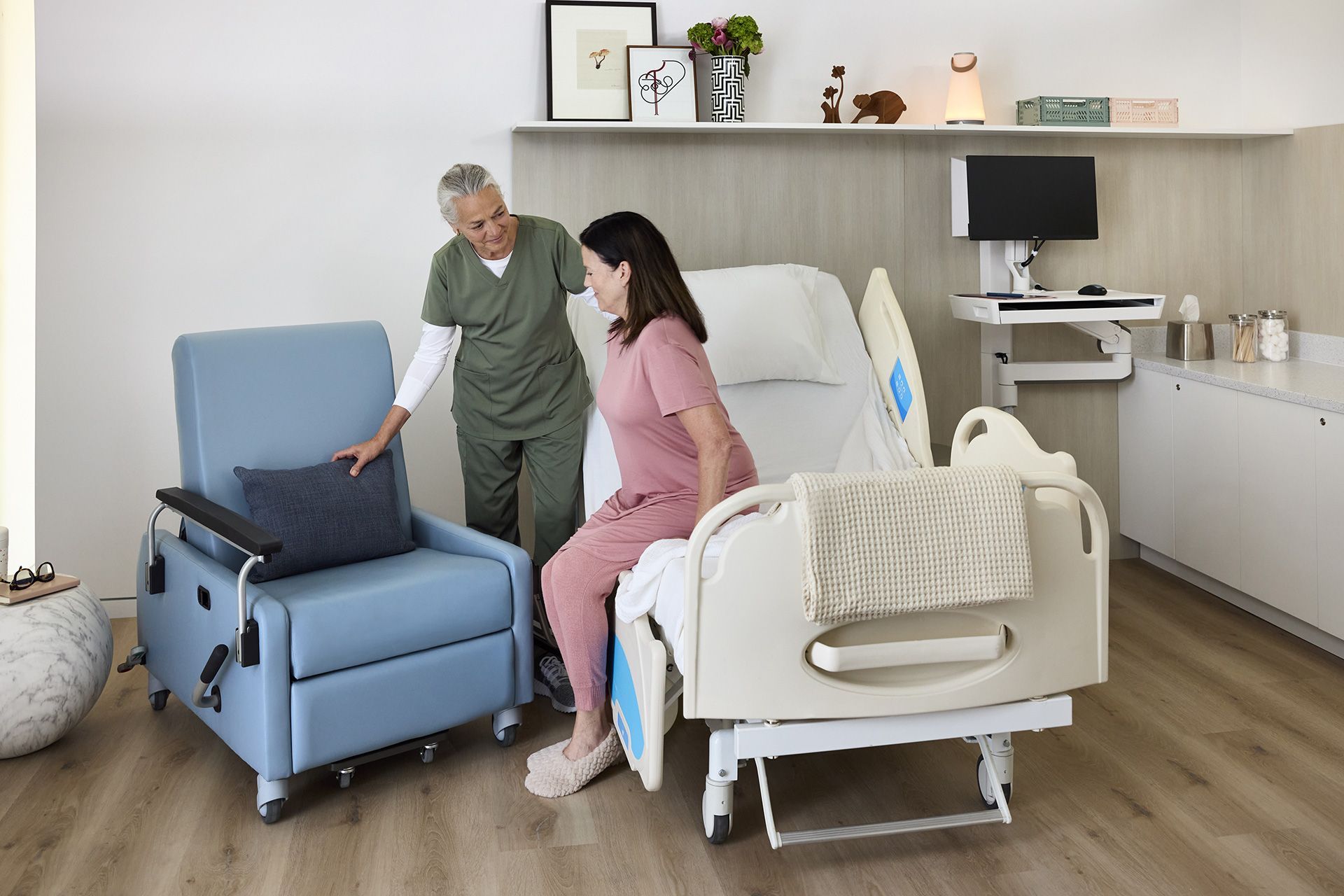 Doctor talking to a boy in a chair. Father and another boy on a couch in a medical office.